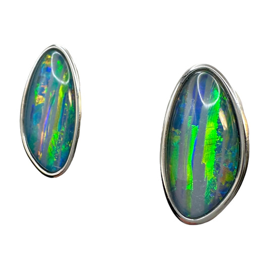 Opal earrings with multicolored gemstones in silver settings on a white background