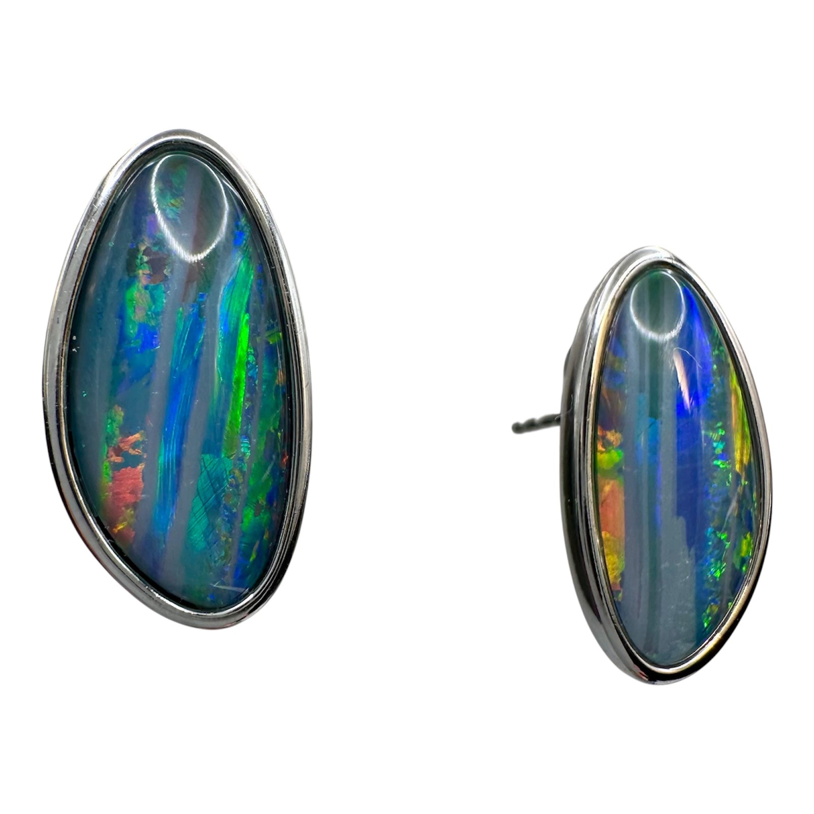 Opal earrings with multicolored play of light on a white background